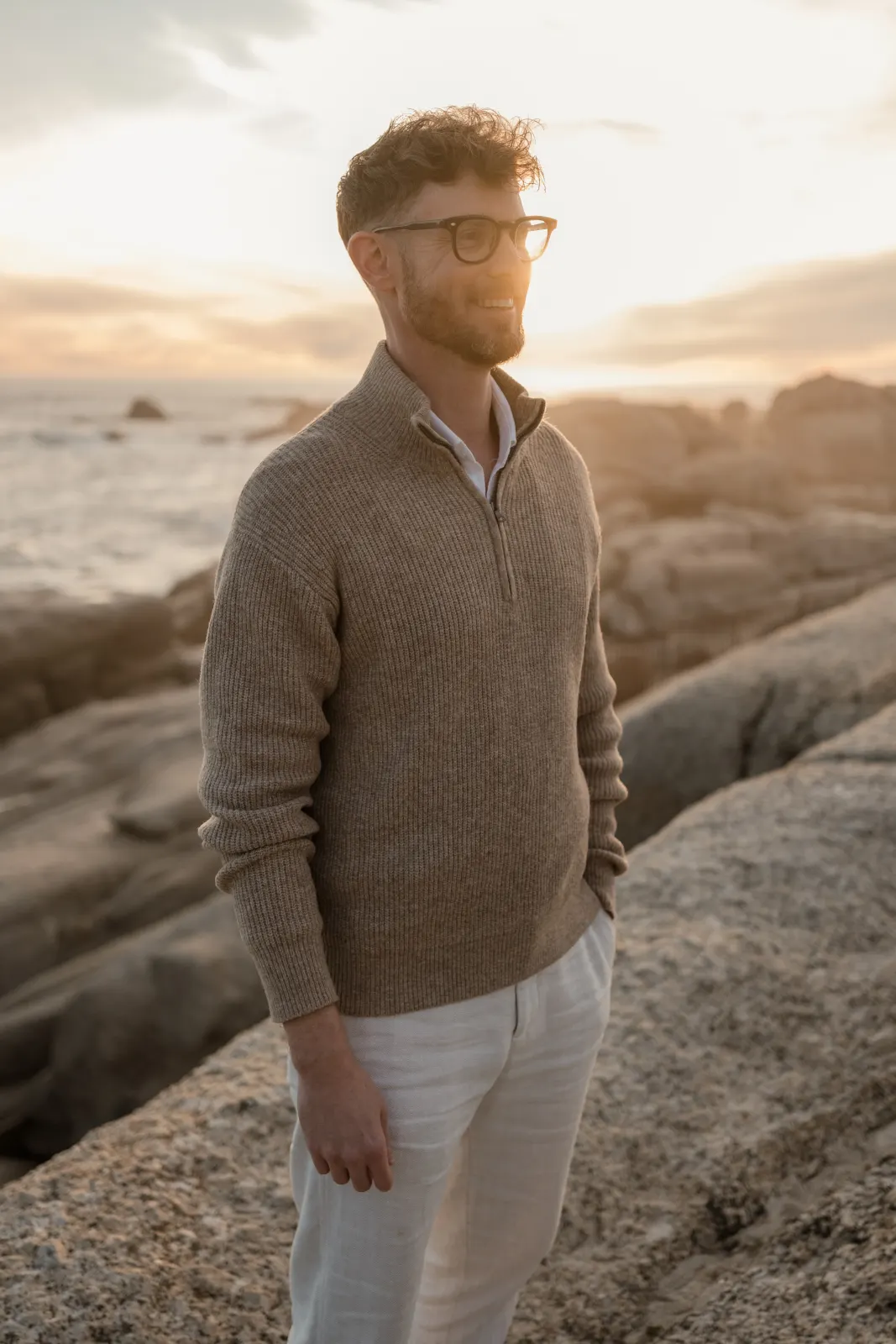 Paul, on the rocks by the sea at sunset