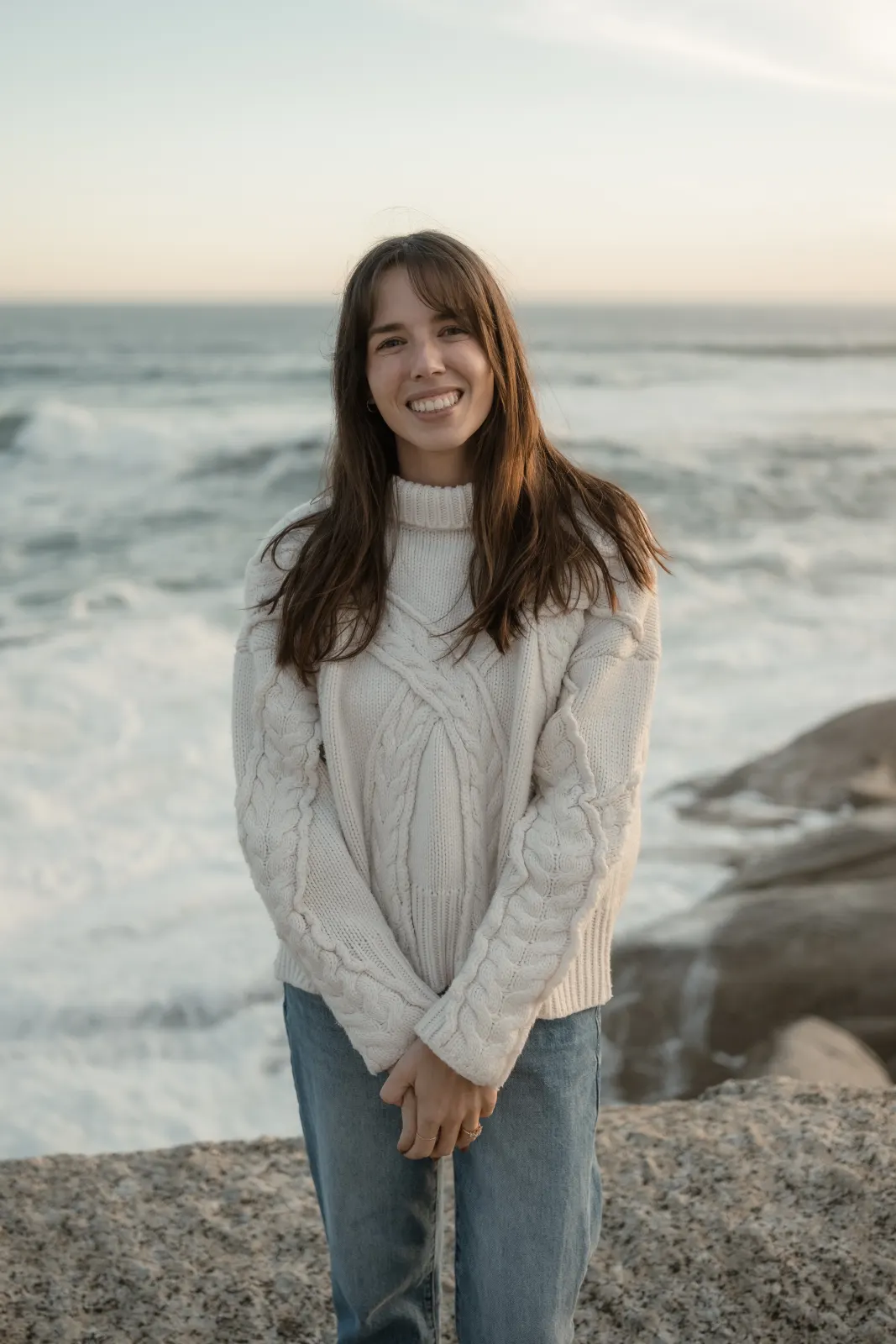 Fran, smiling, with the sea behind her